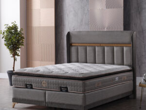 Lit boxspring en tissu gris anthracite avec coffre de rangement et matelas orthopedique ambiance douce et securisante collection DOLCE